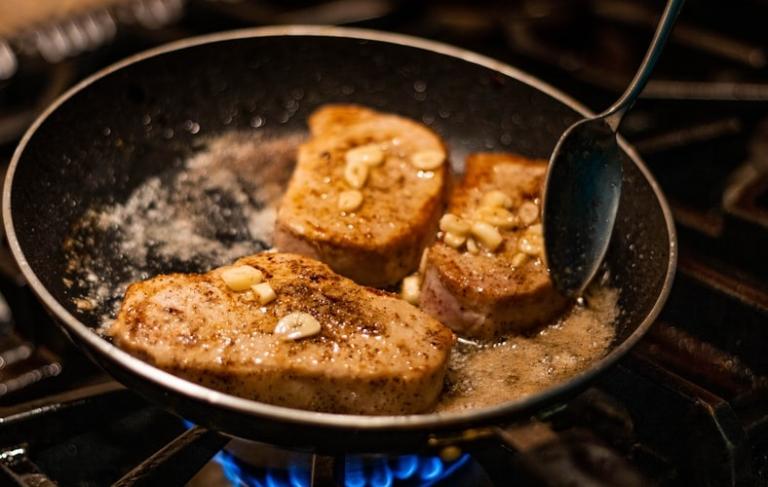 Frying meat in a skillet